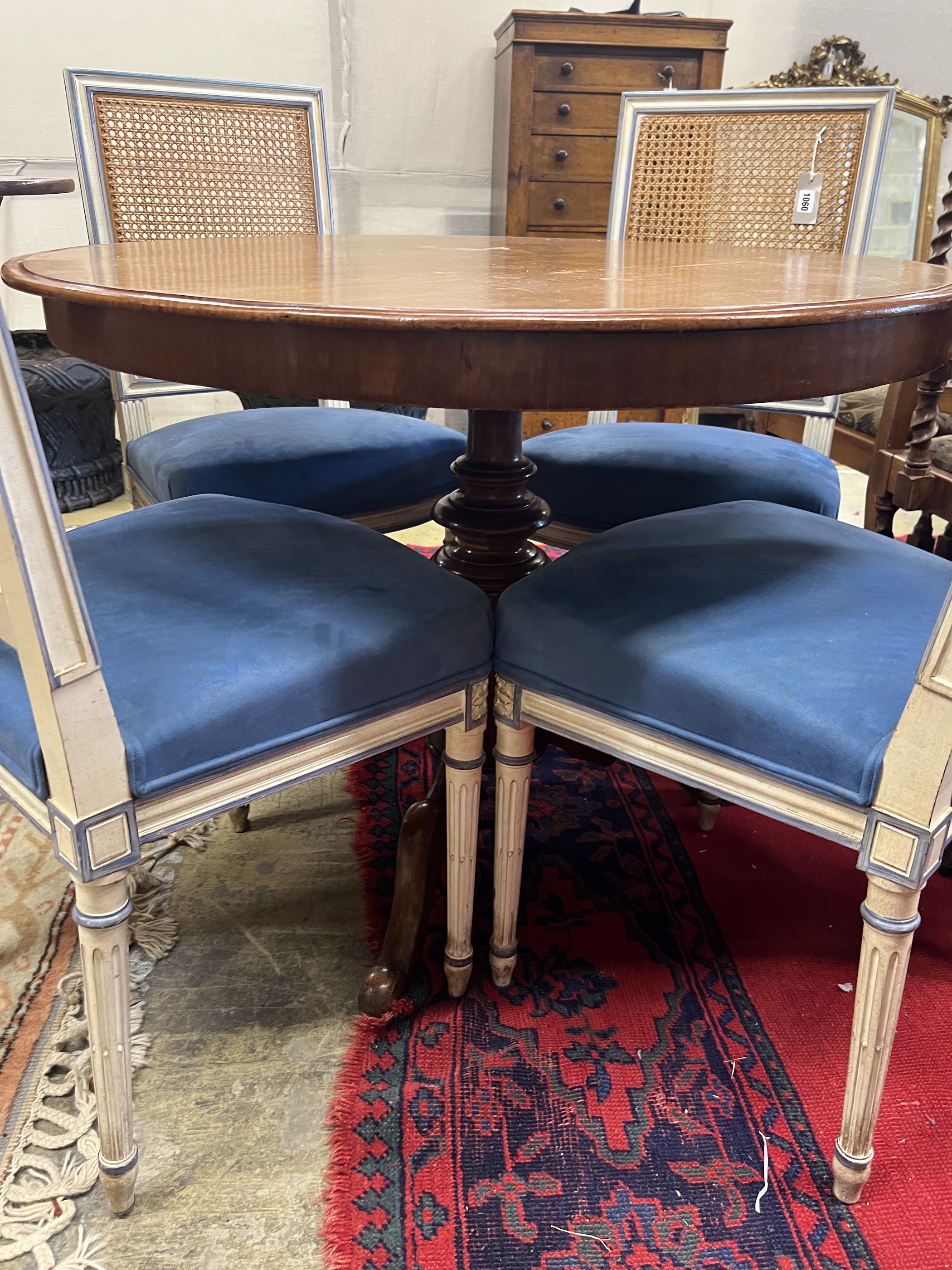 A set of four French style painted caned back dining chairs
